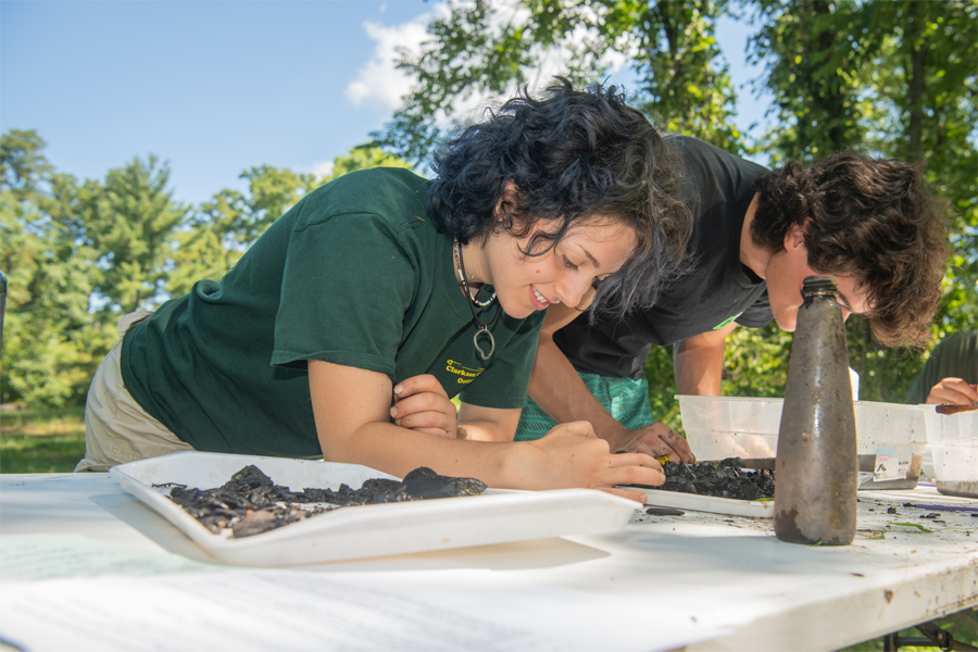 Two students working on a project outside for the Beacon Institute. 