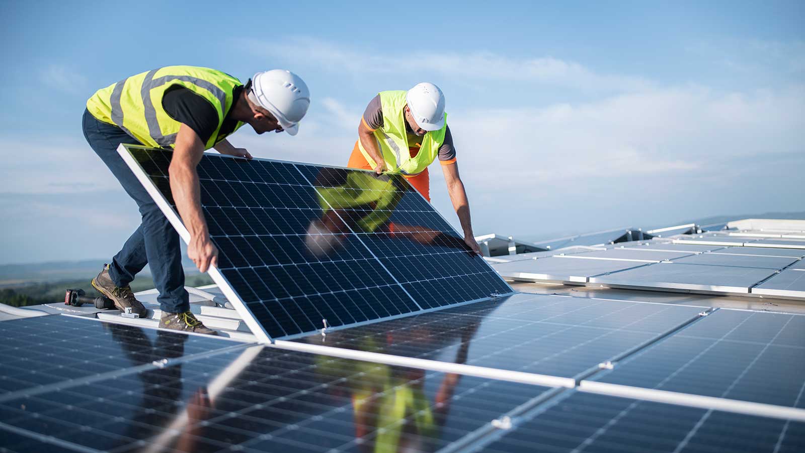 Engineers installing solar panels representing civil environmental engineering program at Clarkson university