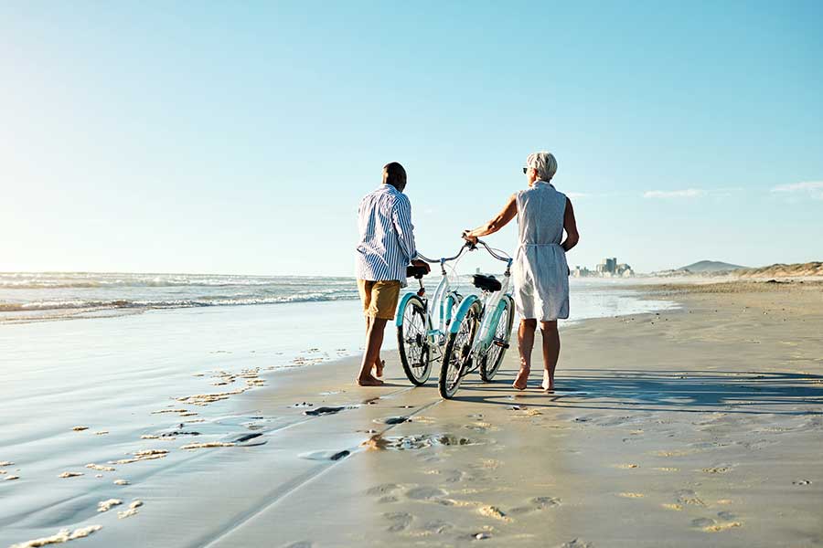 Individuals walking on a beach