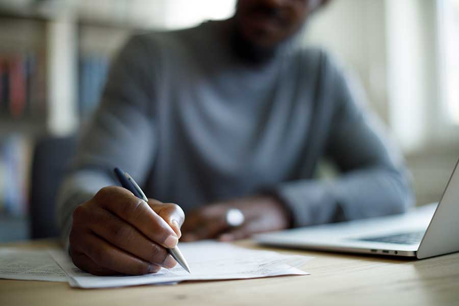 Person writing on paper