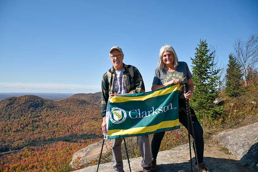 Couple hiking Azure Mountain showing their Clarkson Pride