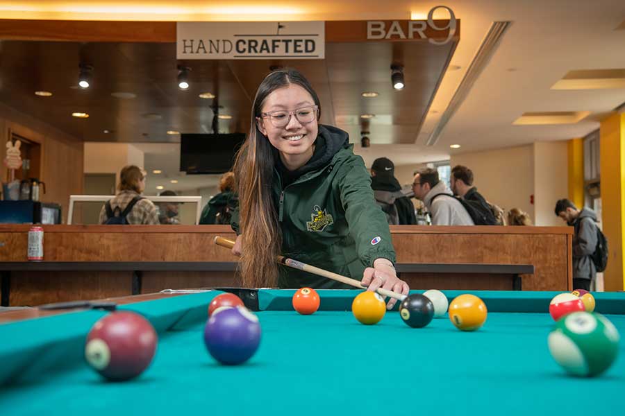 Student playing pool