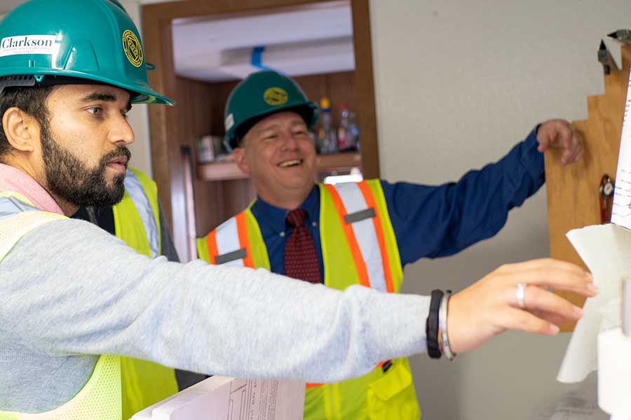 Student working with Professor Backus on a construction project