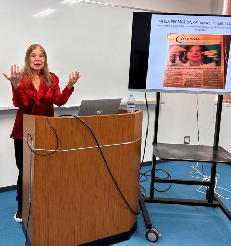 Prof. Dana Barry presents at a podium