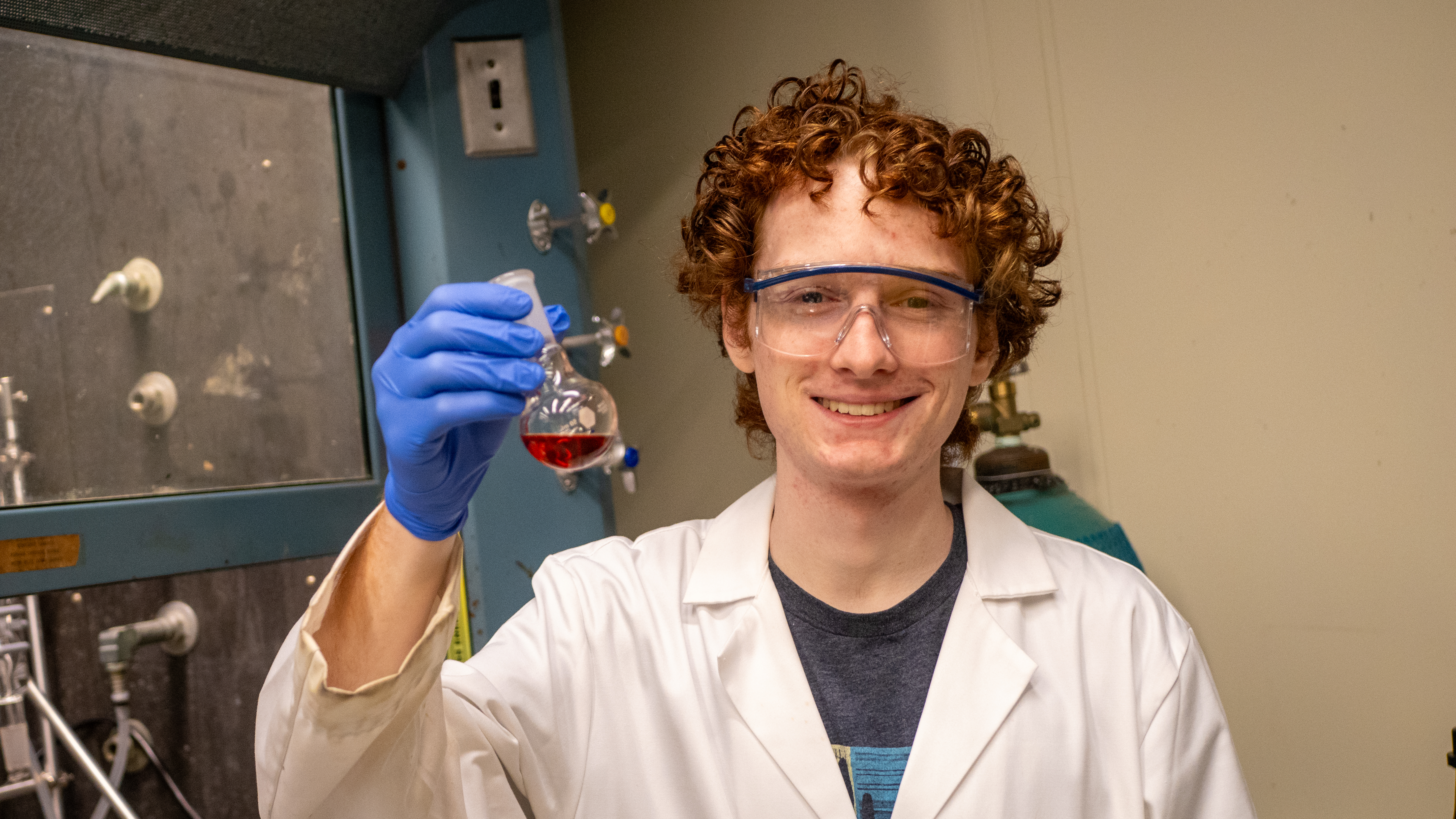 Portrait of Matthias Schmidt holding a beaker