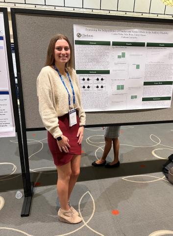 Clarkson student Julia Brzac stands in front of her poster