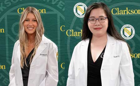 Waist up portrait of Ariana Kelly and Xuan Li, wearing white lab coats.