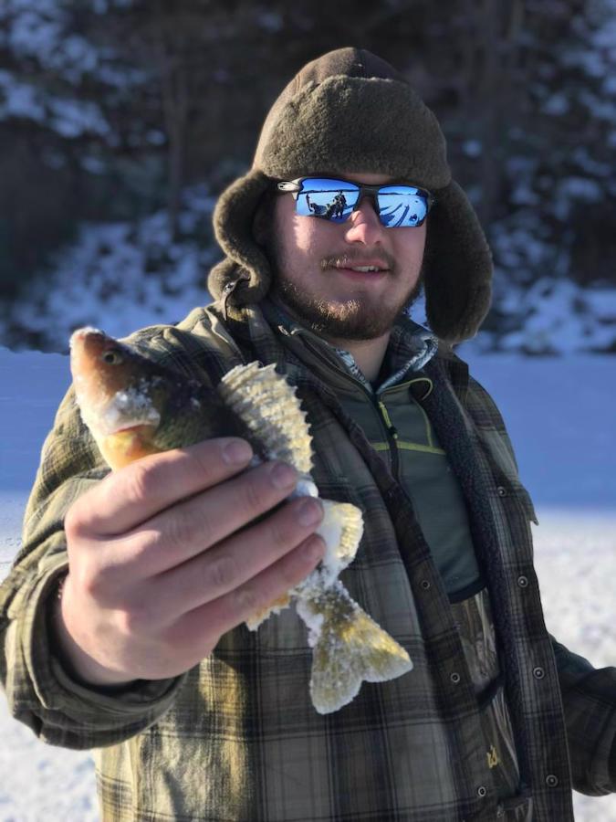 Man holding up a fish in winter clothes