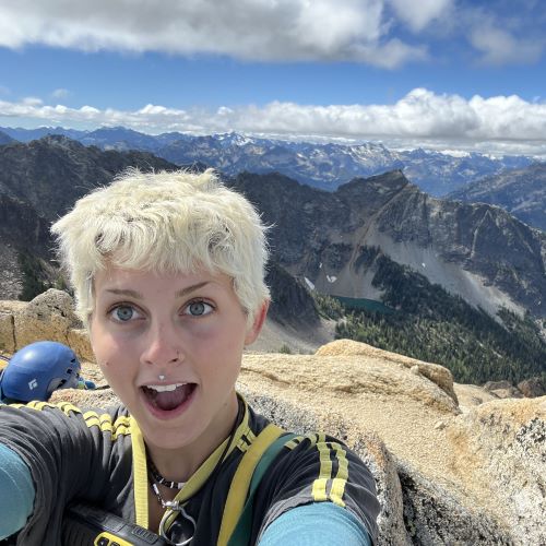 A photo of Angie Zeoli on top of a mountain.