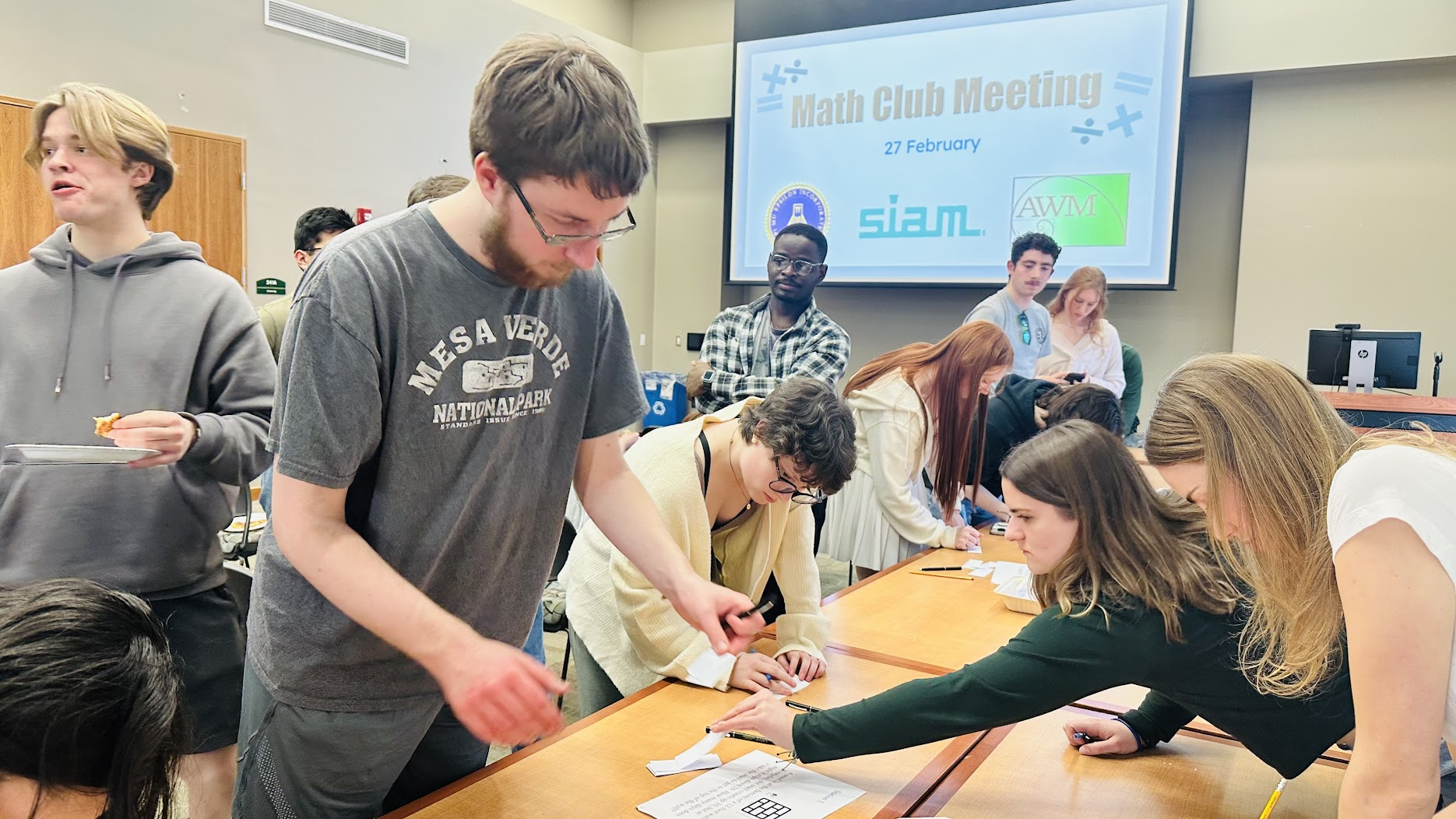 A photo of math club students at a weekly meeting.