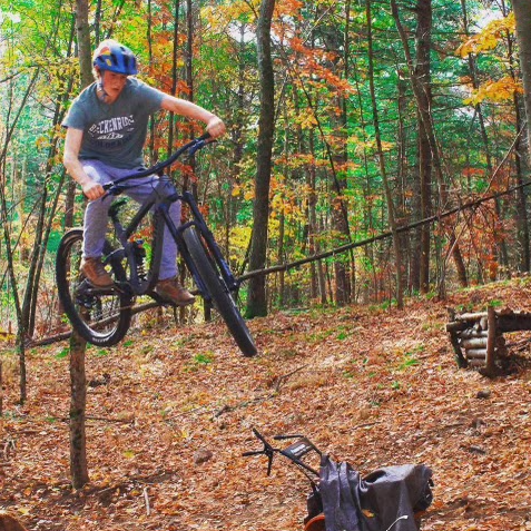 A photo of Ryan May doing a bike trick.