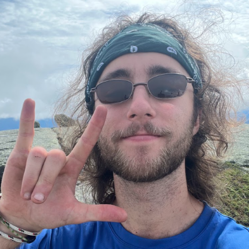 A photo of Seamus Fogerty on top of a mountain.