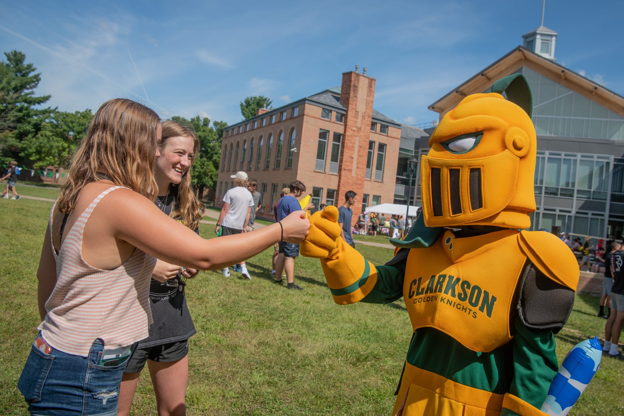 Clarkson student fist bumping Golden Knight. 