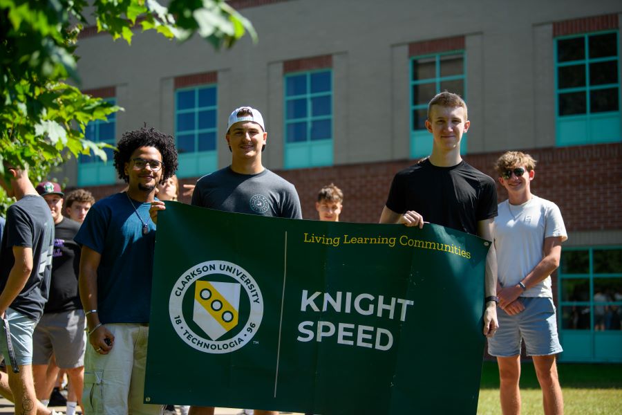 A photo of the fall 2024 knight speed living learning community holding a banner.