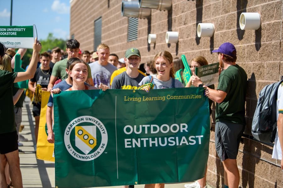 A photo of the fall 2024 outdoor enthusiast living learning community holding a banner.