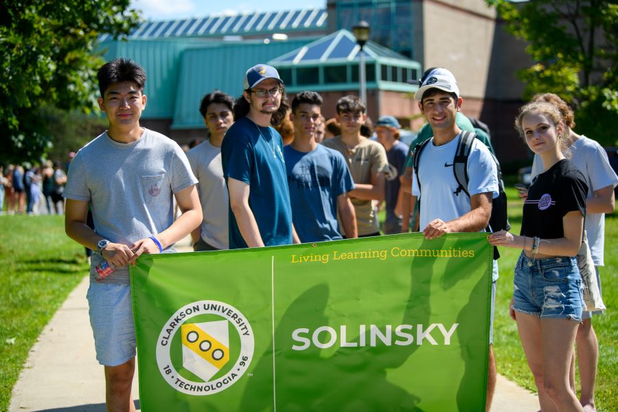 A photo of the Fall 2024 Solinsky living learning community holding a banner